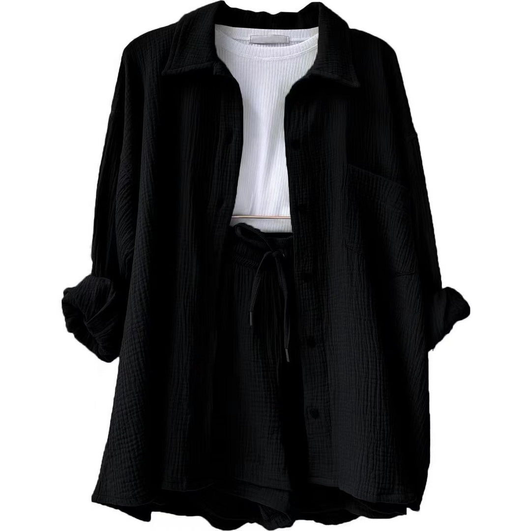 A woman wearing a relaxed button shirt with matching drawstring shorts, fresh and easy.