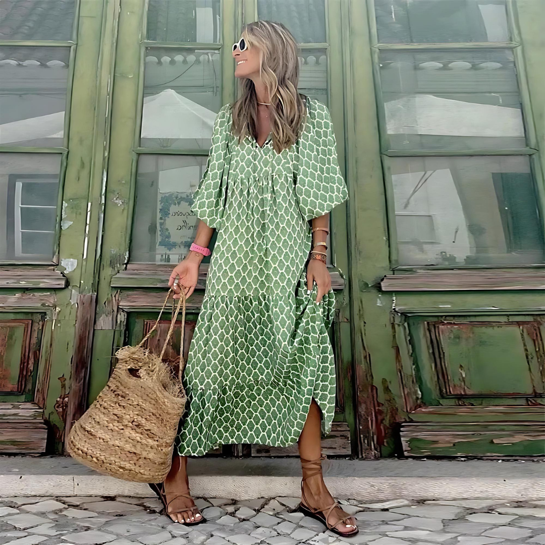 A woman wearing the Erin spring print dress in green and pink tones, styled for a day out.