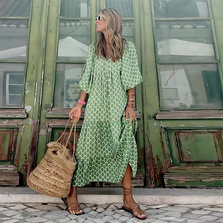 A woman wearing the Erin spring print dress in green and pink tones, styled for a day out.
