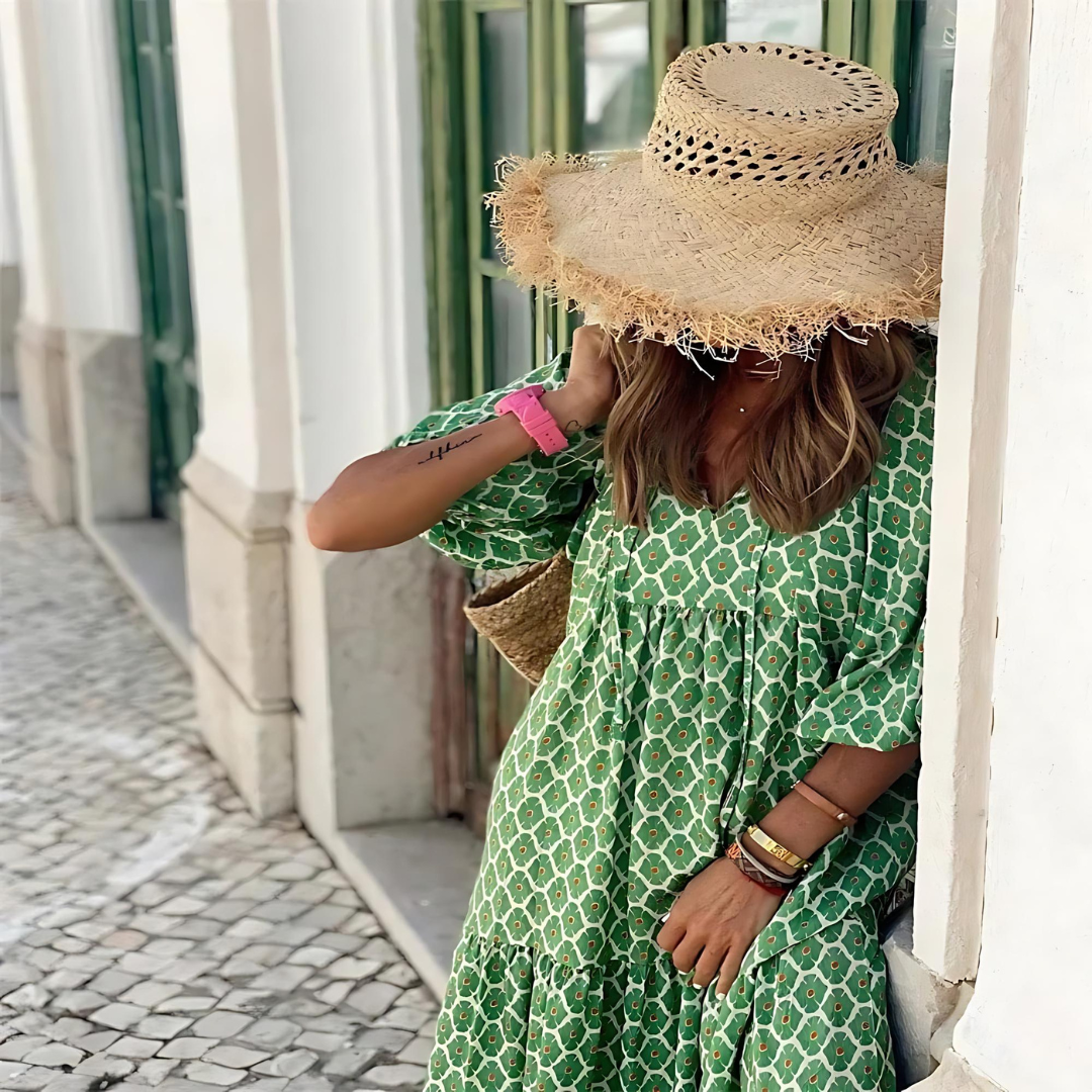 A woman wearing the Erin spring print dress in green and pink tones, styled for a day out.