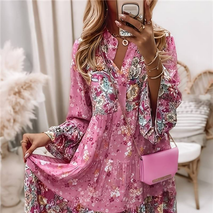 Woman in a relaxed boho dress with a colourful paisley and floral print.