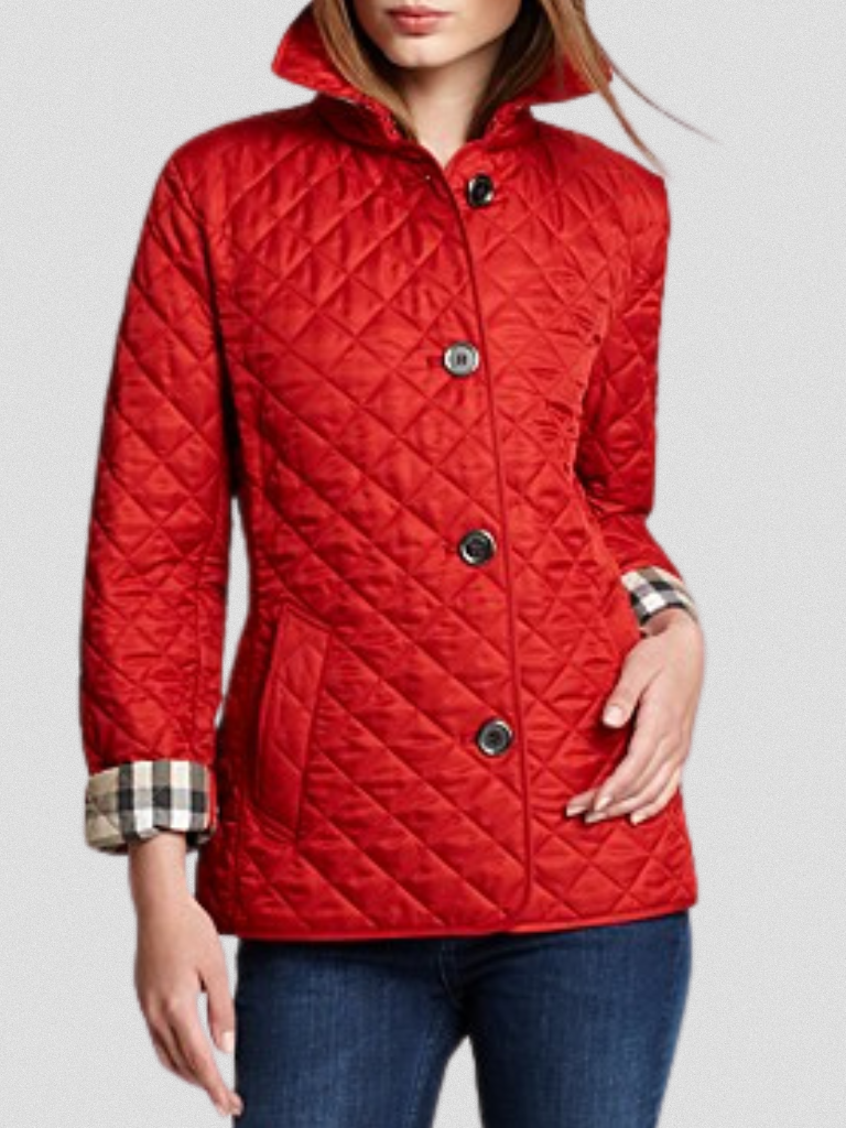 A woman wearing an fall jacket over a top, layered for a crisp day in town.