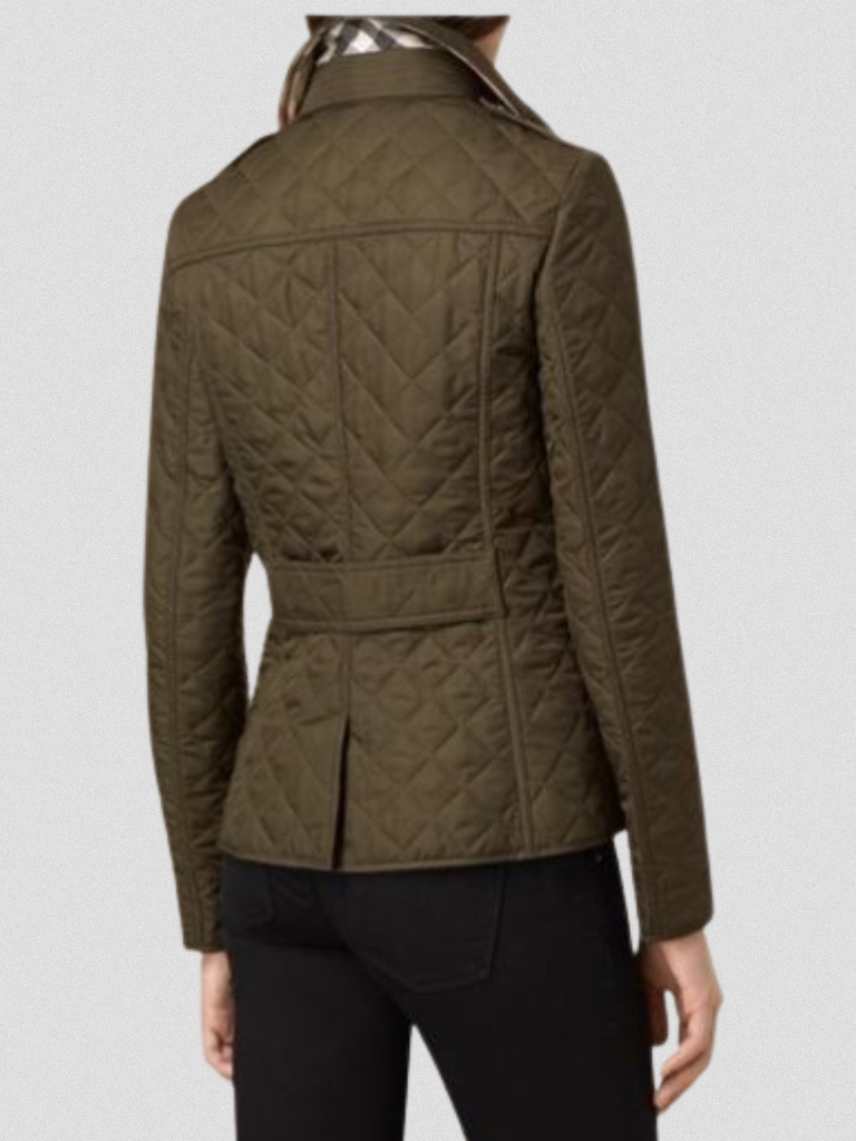 A woman wearing an fall jacket over a top, layered for a crisp day in town.