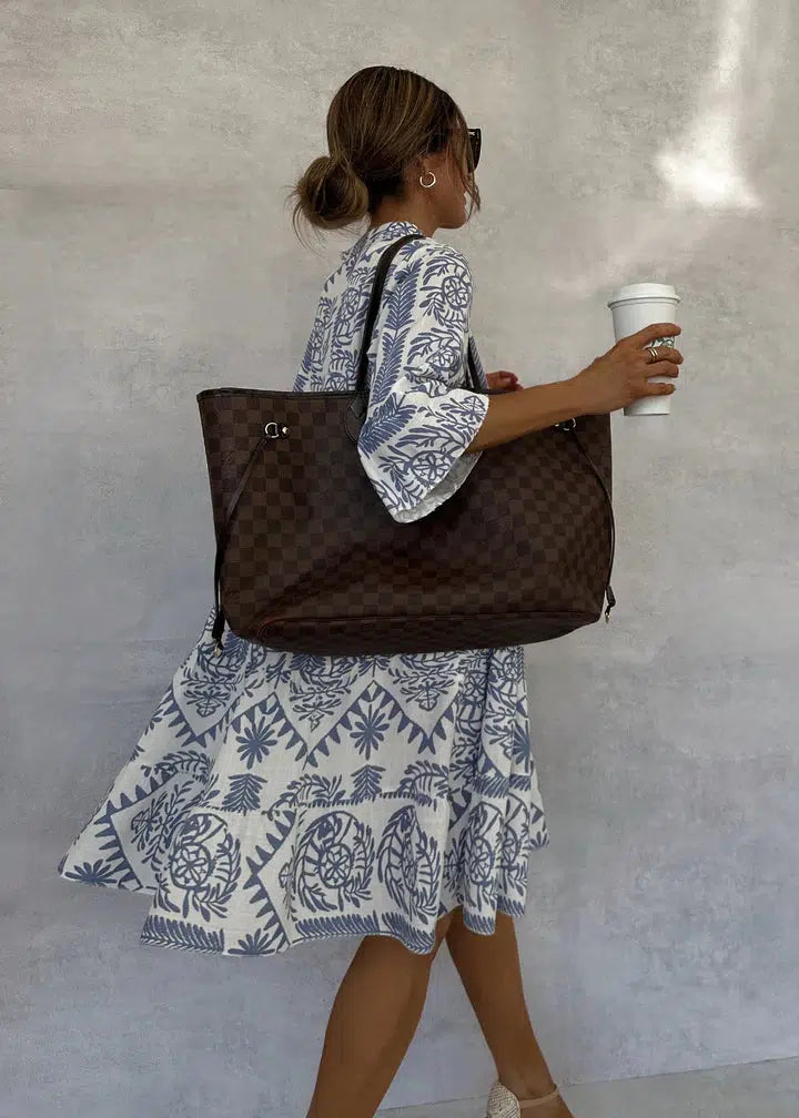 Woman wearing the Elaine button-front boho tunic dress, relaxed on a casual day out.