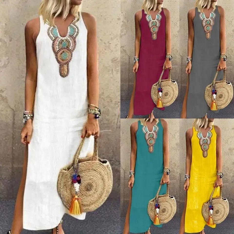 Woman in a sleeveless midi dress with embroidered neckline strolling in the summer sun.