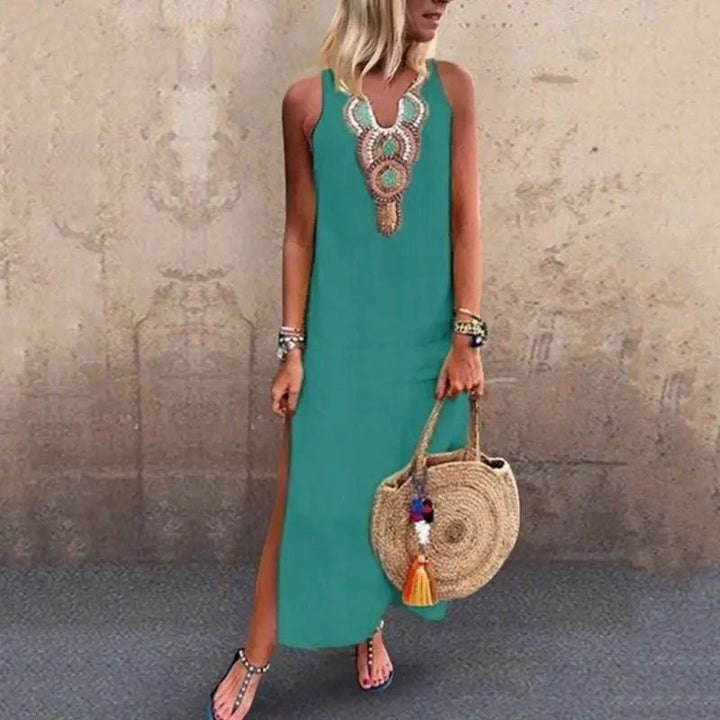 Woman in a sleeveless midi dress with embroidered neckline strolling in the summer sun.