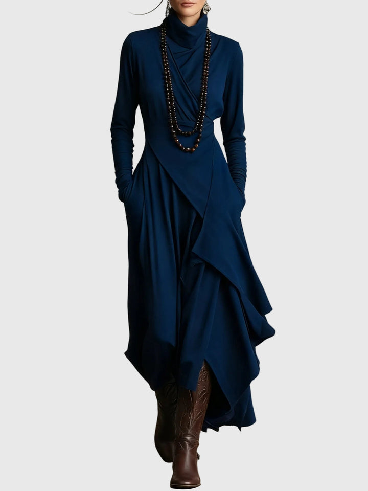 Woman wearing the Nancy draped high-neck maxi dress in violet with ankle boots.