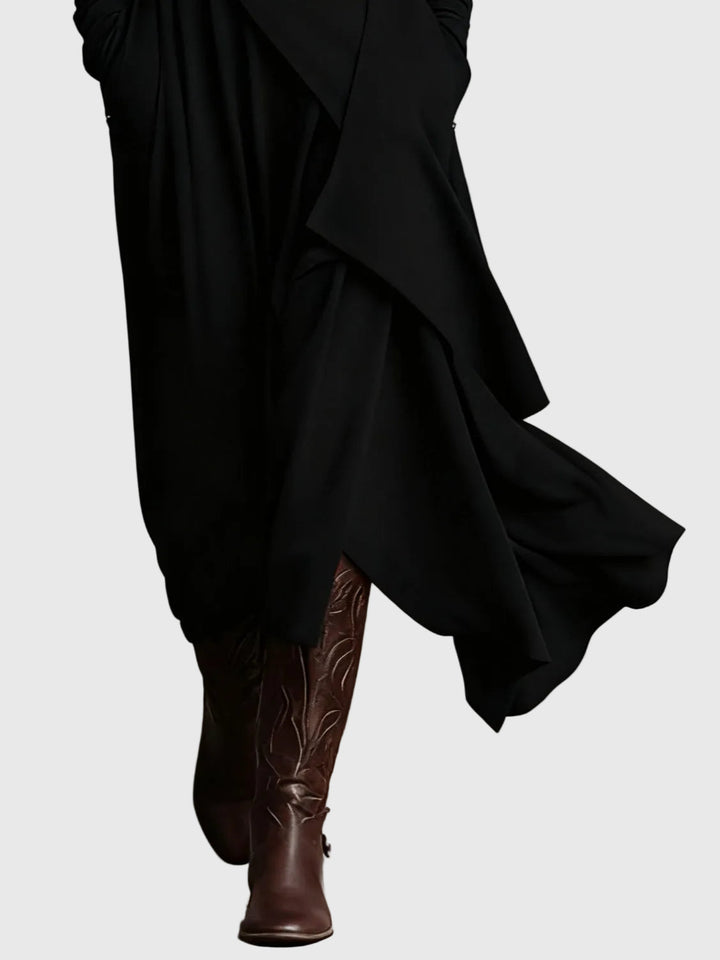 Woman wearing the Nancy draped high-neck maxi dress in violet with ankle boots.
