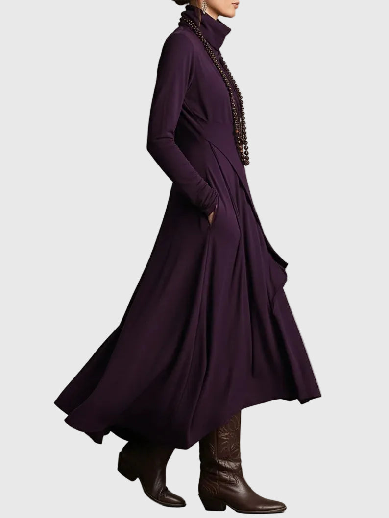 Woman wearing the Nancy draped high-neck maxi dress in violet with ankle boots.