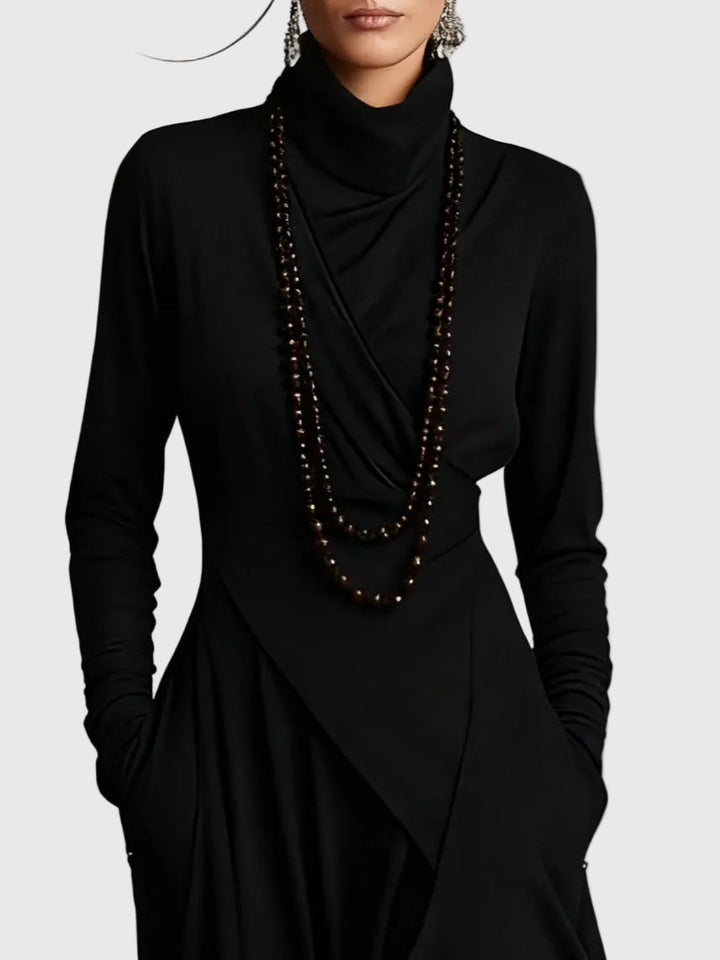Woman wearing the Nancy draped high-neck maxi dress in violet with ankle boots.