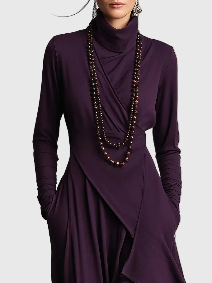 Woman wearing the Nancy draped high-neck maxi dress in violet with ankle boots.