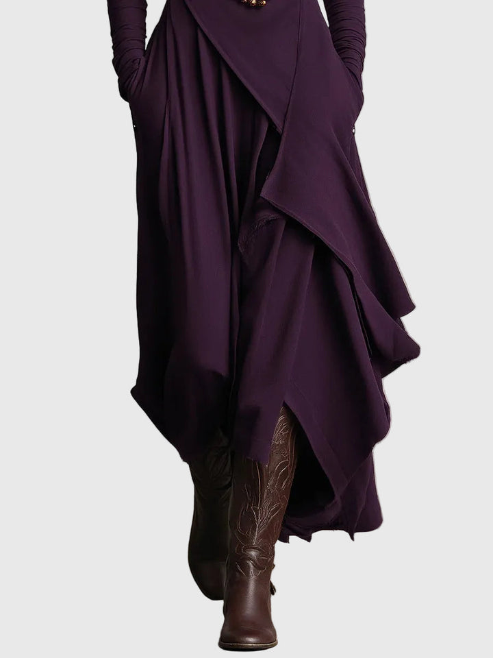 Woman wearing the Nancy draped high-neck maxi dress in violet with ankle boots.