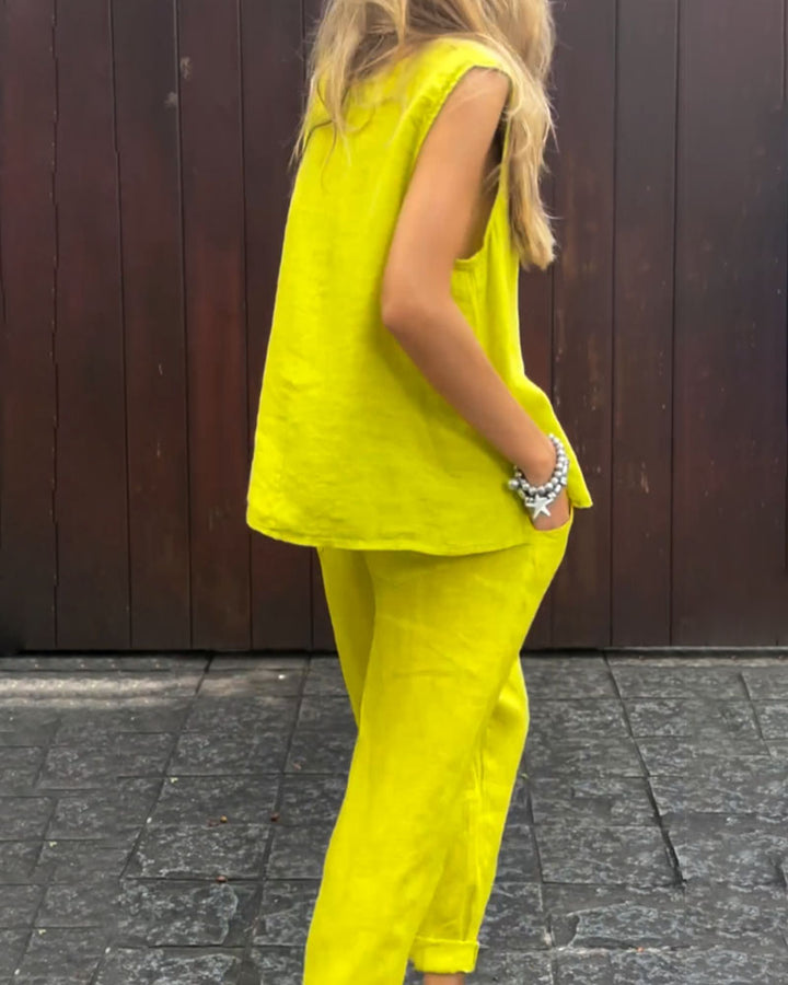A woman wearing a relaxed sleeveless top with ankle-length pants, easy and elegant.