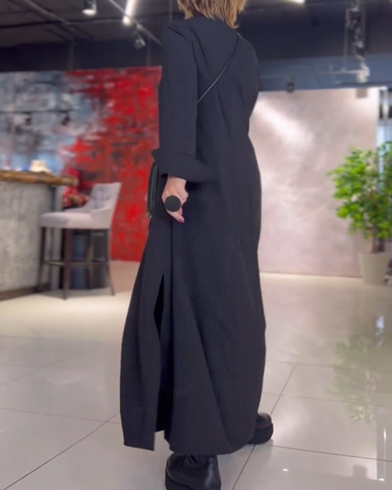 Woman wearing the Patricia relaxed maxi dress with revere collar, standing by a doorway.