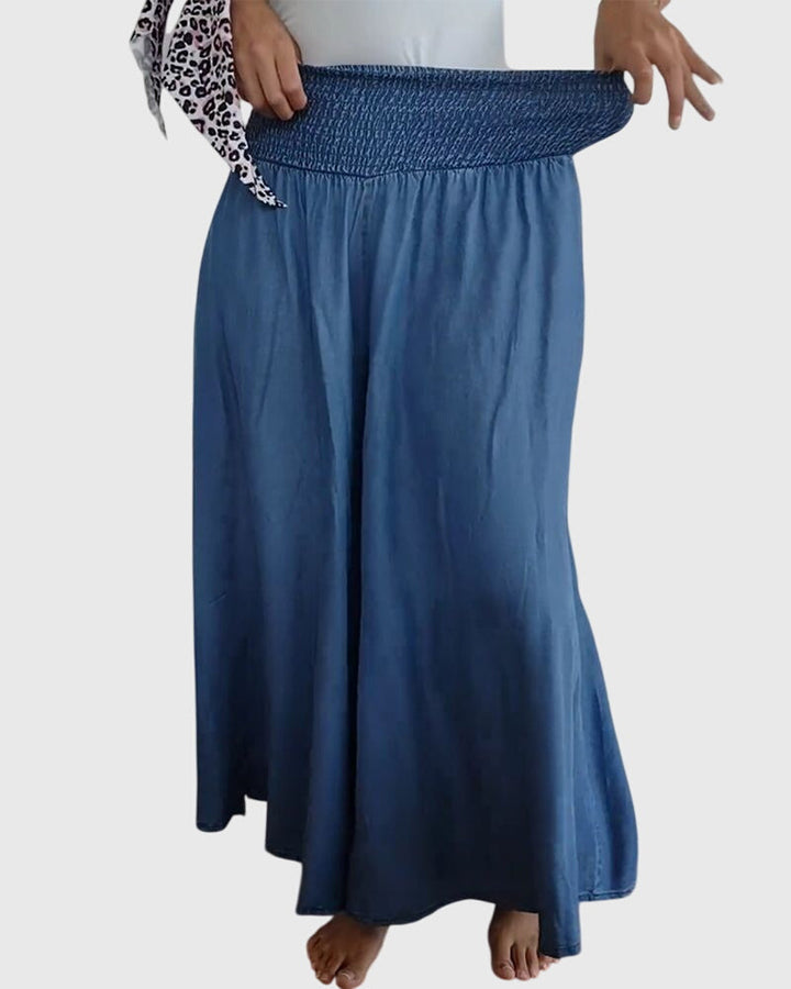 A woman in wide-leg pants with a high elastic waist, styled for a relaxed boho look.