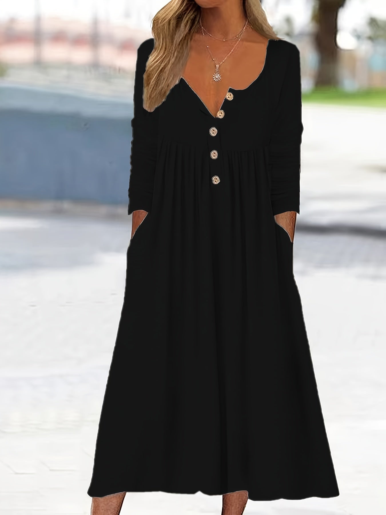 A woman wearing the Tina button-front midi dress with an A-line skirt, dressed for a casual day out.