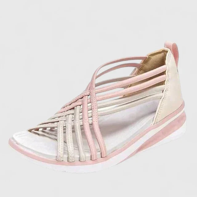 A woman walking with ease in elegant wide-fit everyday sandals with a cushioned footbed.