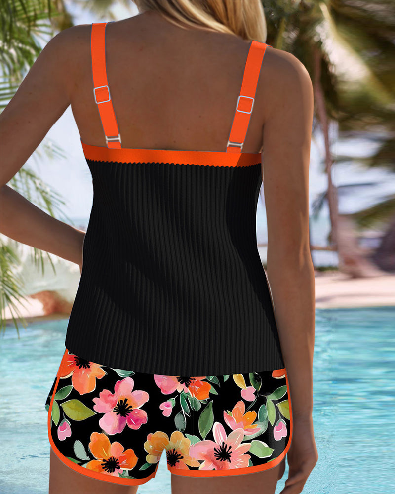 A woman at the water's edge in a bright printed two-piece tankini, relaxed and confident.