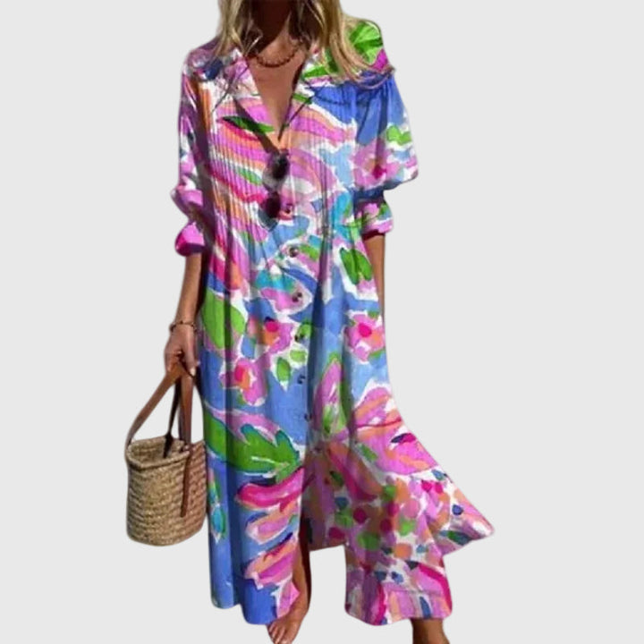 Woman in a long flowing boho-style maxi dress with delicate patterns, walking outdoors.