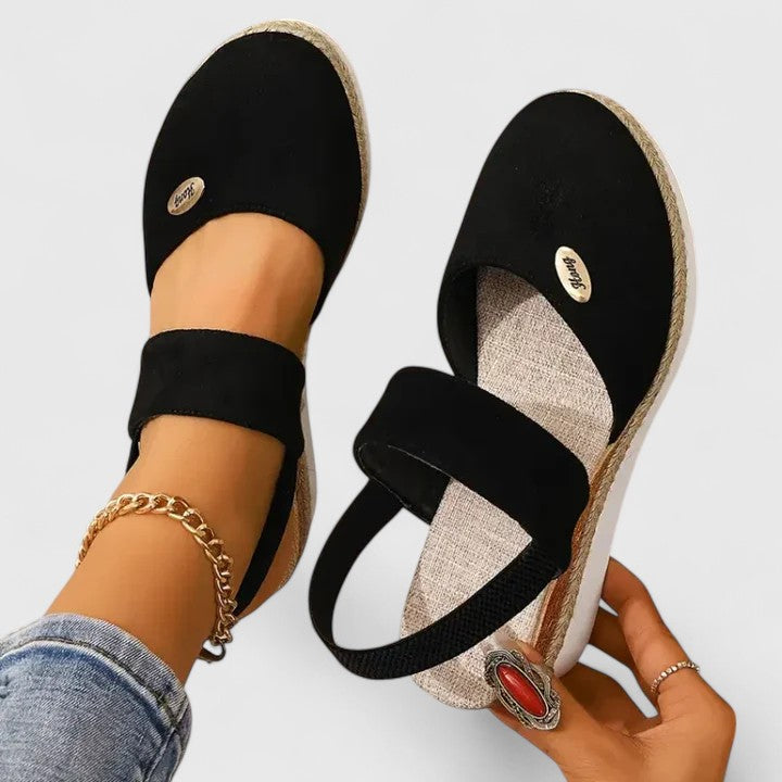 A woman in beige espadrille-inspired sandals stepping out comfortably on a bright morning.
