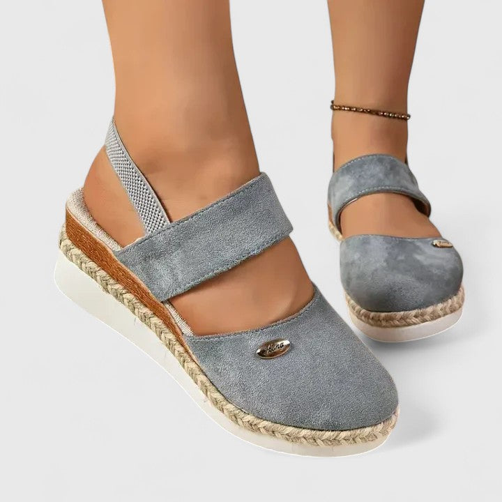 A woman in beige espadrille-inspired sandals stepping out comfortably on a bright morning.
