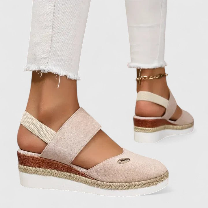 A woman in beige espadrille-inspired sandals stepping out comfortably on a bright morning.