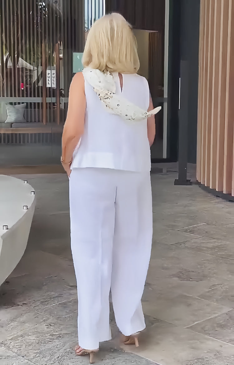A woman wearing a chic minimal two-piece set with a soft, flattering silhouette.