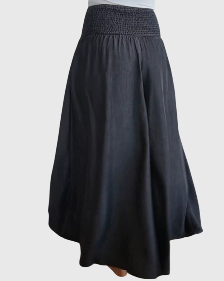 A woman in wide-leg pants with a high elastic waist, styled for a relaxed boho look.