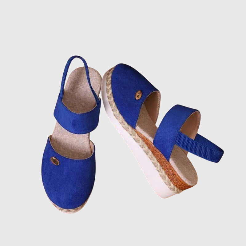 Black closed-toe wedge espadrilles with a wide stretch strap and a braided-trim platform wedge.