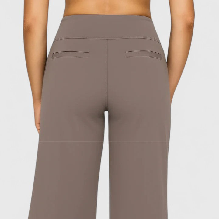 Woman wearing pull-on pants with a soft blouse, relaxed and comfortable at home.
