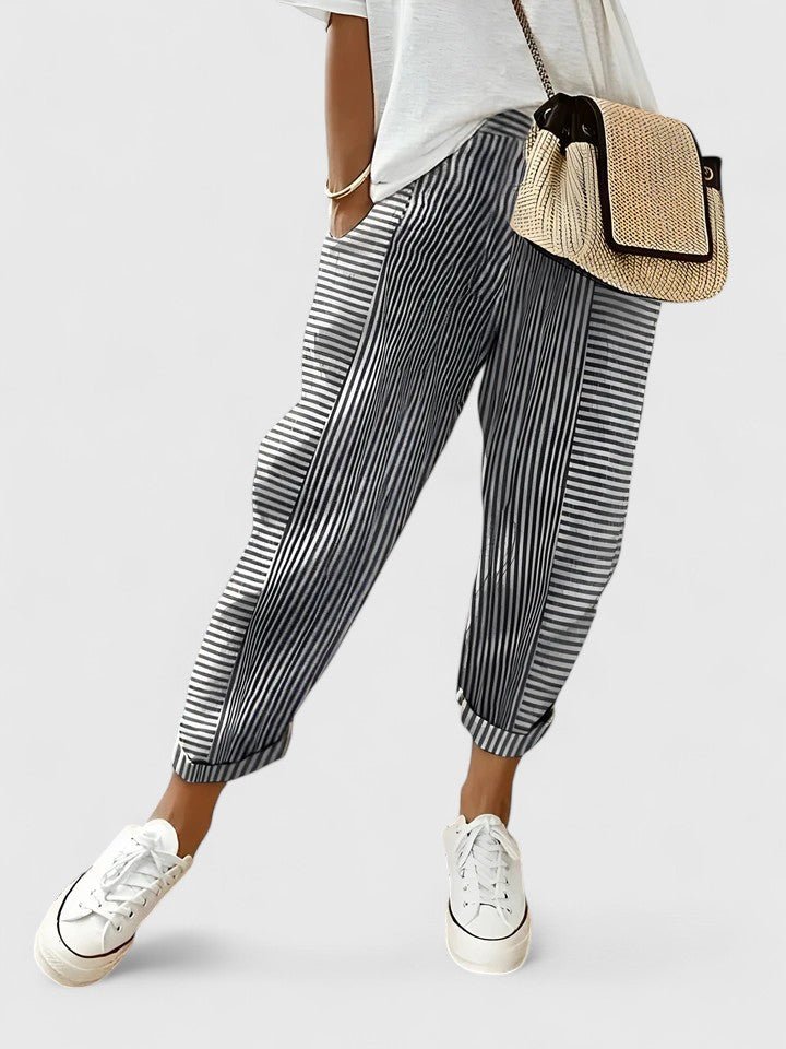 A woman wearing airy comfy summer pants with an elastic waist and side pockets.
