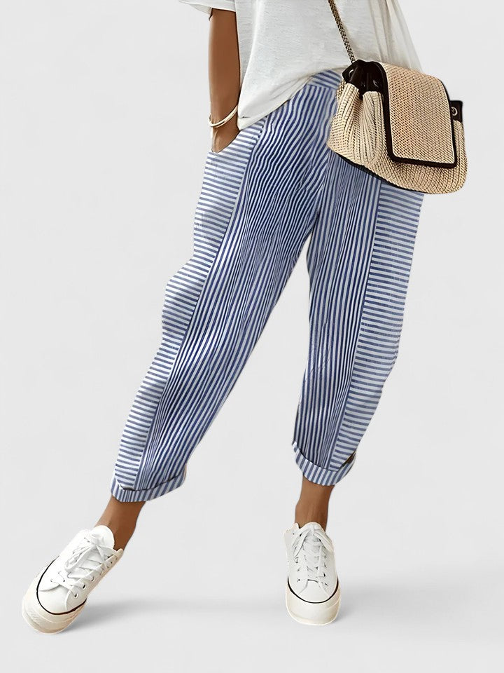 A woman wearing airy comfy summer pants with an elastic waist and side pockets.