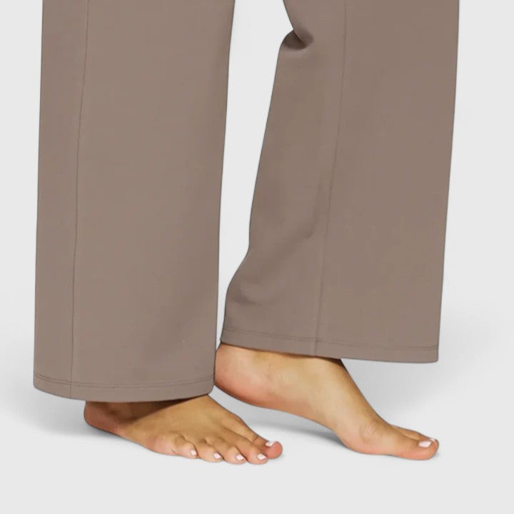 Woman wearing pull-on pants with a soft blouse, relaxed and comfortable at home.