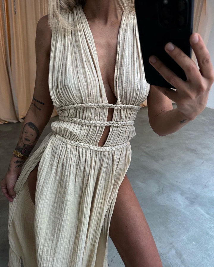 Woman in a softly textured dress with front slit and cinched waist tie at golden hour.