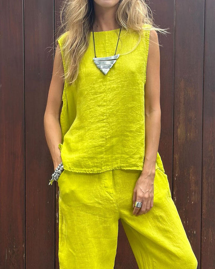 A woman wearing a relaxed sleeveless top with ankle-length pants, easy and elegant.