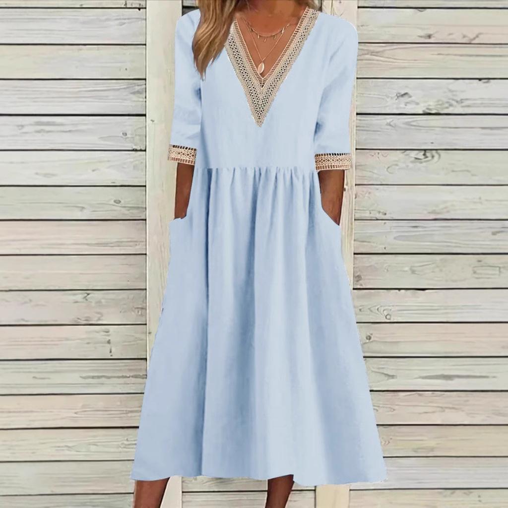A woman wearing the Anne V-neck midi dress with delicate detailing at the collar and sleeves.