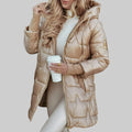 A woman wearing a hooded fall coat in a timeless tone, sheltered from the wind.