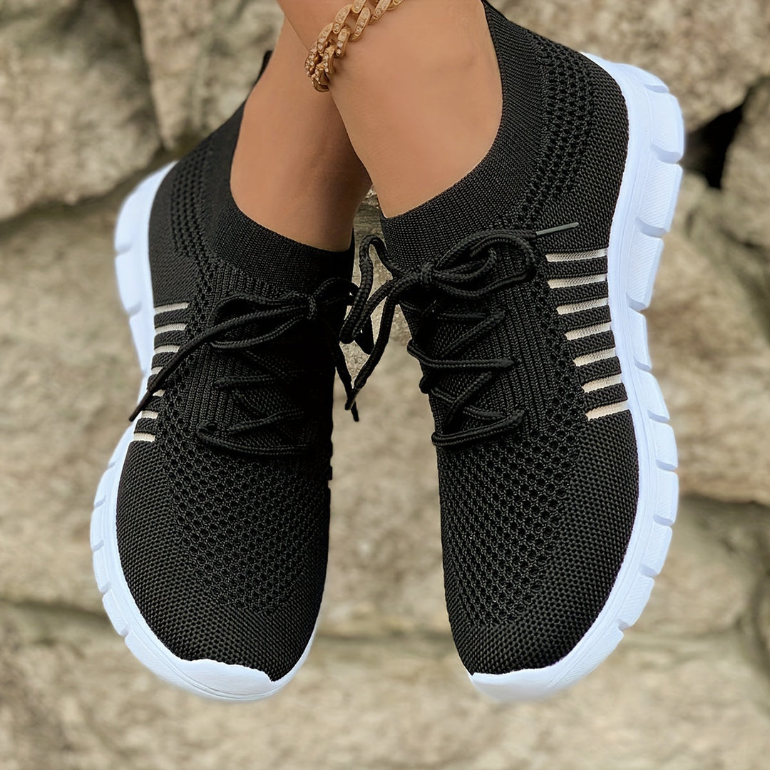 A woman wearing light breathable sock-style comfort shoes