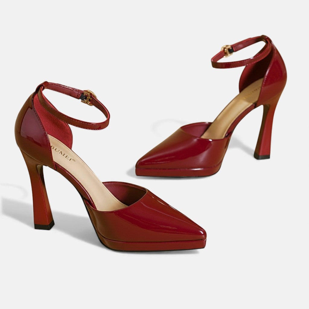 A woman in pointed ankle-strap pumps with a block heel, dressed for a day-to-night occasion.