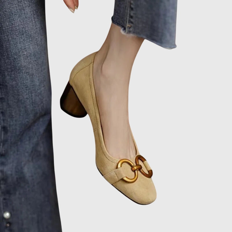 A woman wearing elegant high heels with a tailored evening outfit