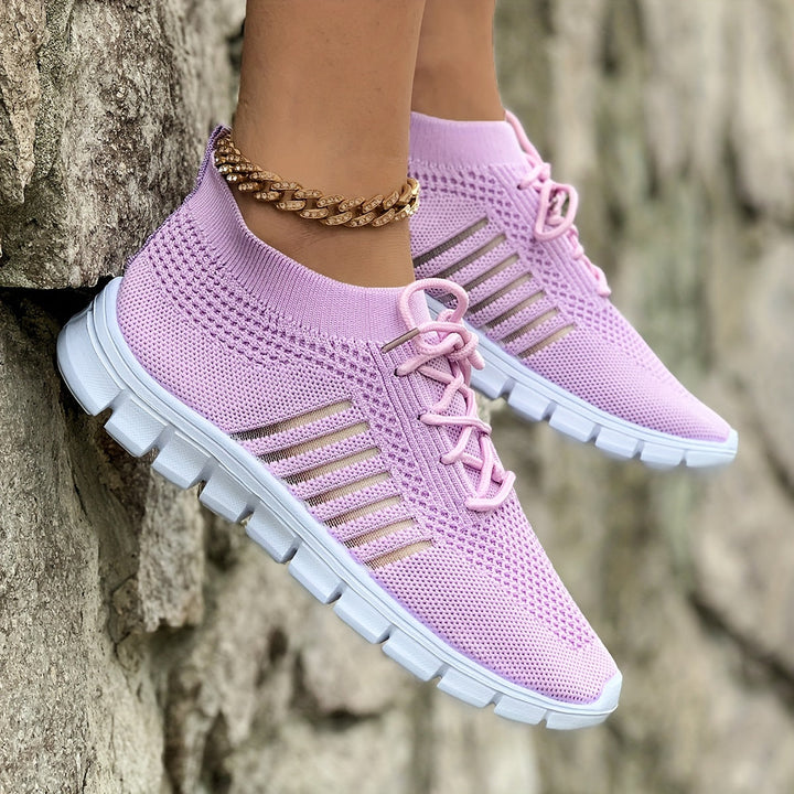 A woman wearing light breathable sock-style comfort shoes