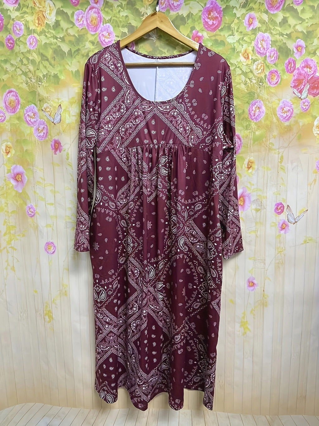 A woman wearing the Maria long sleeve grey paisley midi dress with a square neckline and flowing skirt, styled for a relaxed day out.