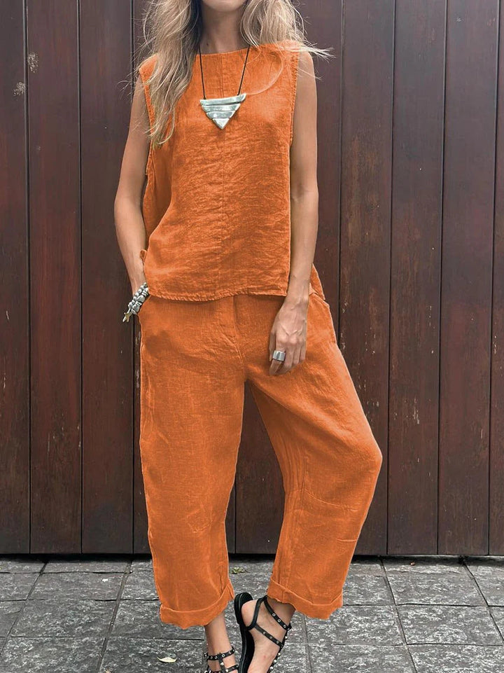 A woman wearing a relaxed sleeveless top with ankle-length pants, easy and elegant.
