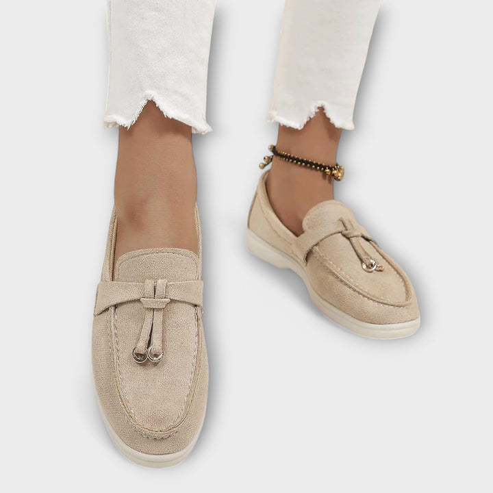 A woman wearing elegant loafers on a polished day out in the city.