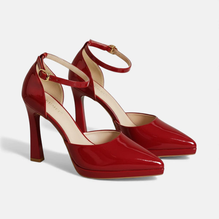 A woman in pointed ankle-strap pumps with a block heel, dressed for a day-to-night occasion.