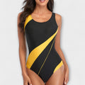 A woman by the pool in a sporty open-back swimsuit, poised and active in the sunshine.