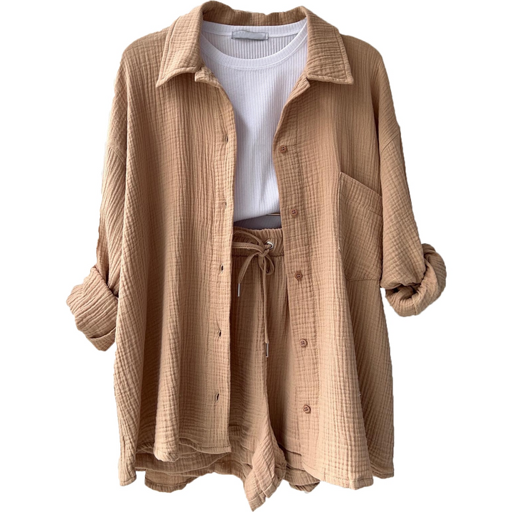 A woman wearing a relaxed button shirt with matching drawstring shorts, fresh and easy.