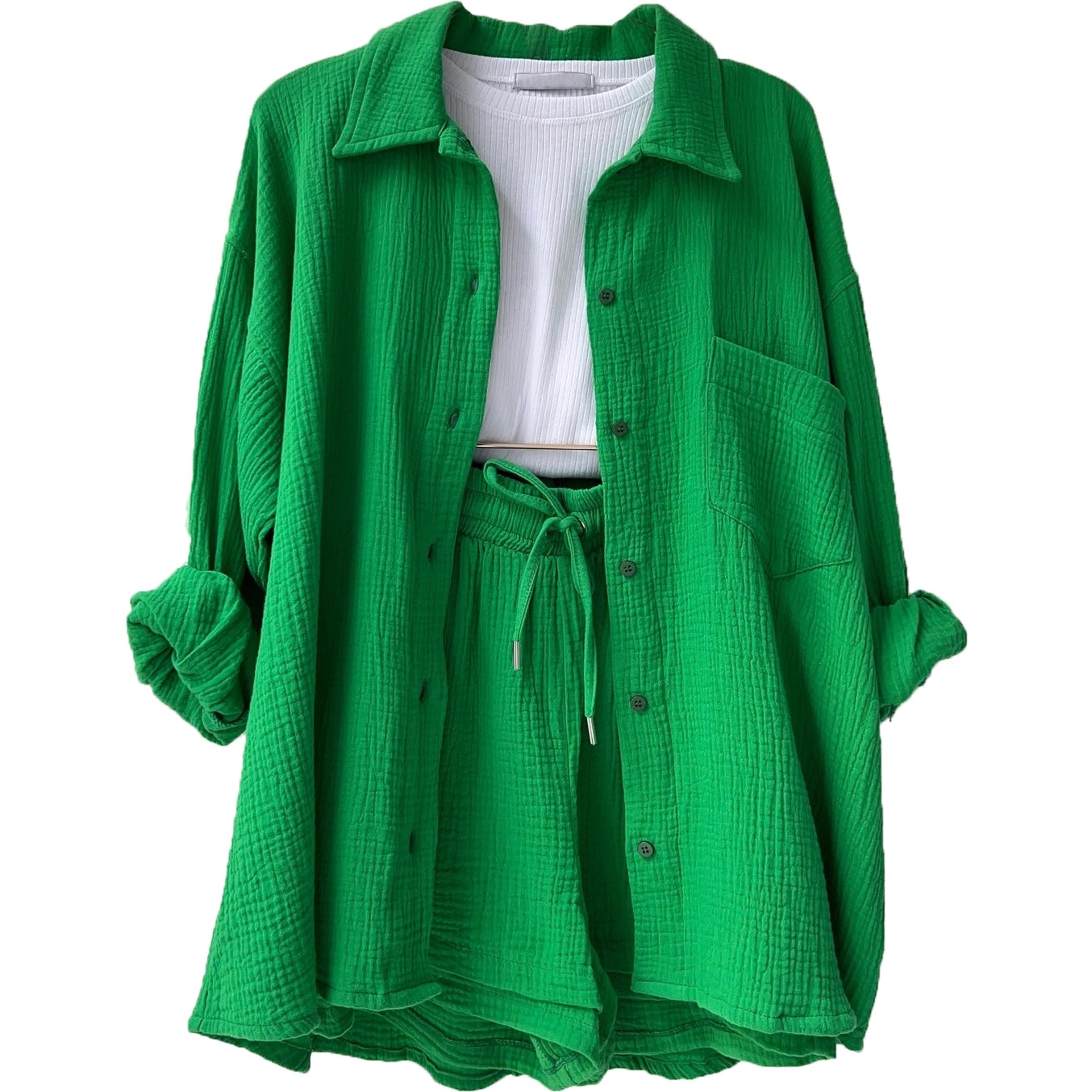 A woman wearing a relaxed button shirt with matching drawstring shorts, fresh and easy.