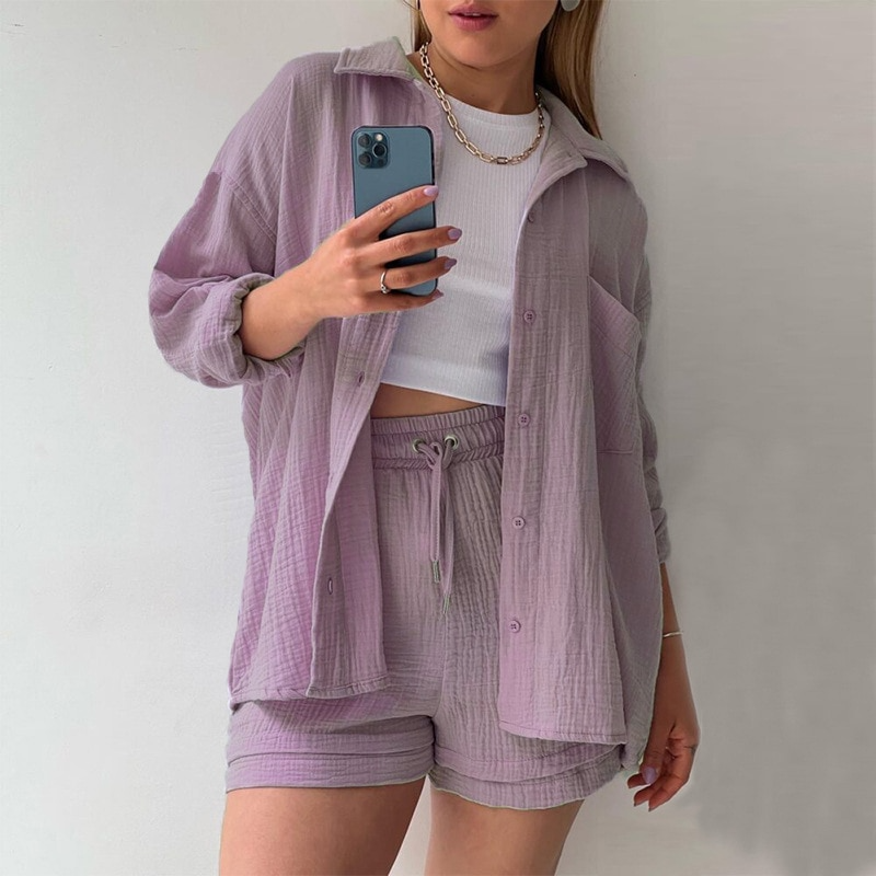 A woman wearing a relaxed button shirt with matching drawstring shorts, fresh and easy.