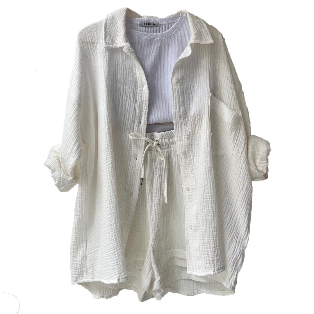 A woman wearing a relaxed button shirt with matching drawstring shorts, fresh and easy.